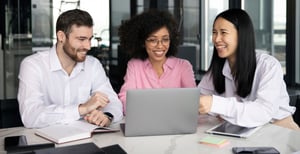 colleagues-working-together-laptop-documents