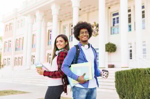 diverse-young-male-female-student-holding-books-takeaway-coffee-cup-standing-front-building