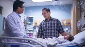 father-discussing-his-babys-health-with-doctor-hospital-room