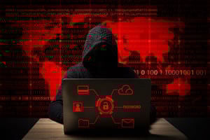 hacker-jacket-with-hood-with-laptop-sits-table