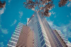 low-angle-shot-tall-business-building-with-blue-cloudy-sky