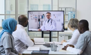 mature-doctor-screen-having-video-call-with-his-colleagues-online-meeting-office