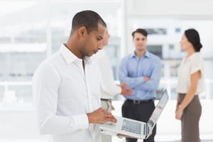 young-businessman-using-laptop-with-team-him